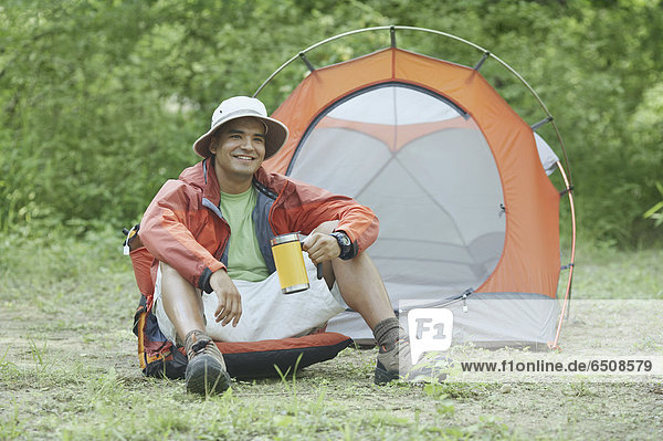 Young man at his campsite