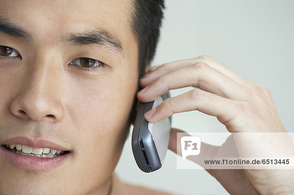 Close up of young man with mobile phone