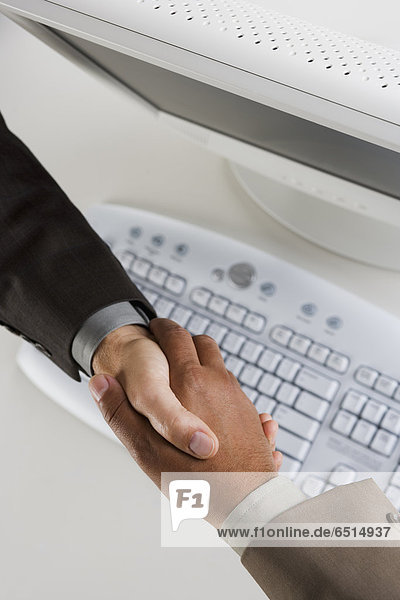 High angle view of two businessman's hands shaking
