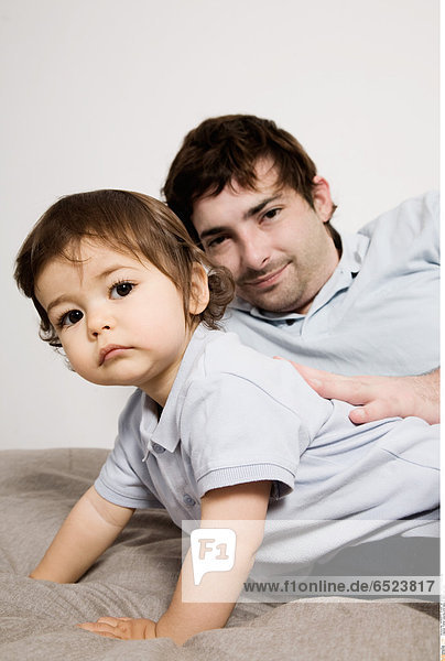 Father playing with baby in the living room
