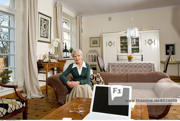 Old lady sitting in the living room