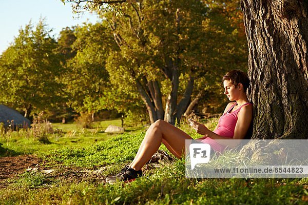 Junge Frau entspannenden unter Baum