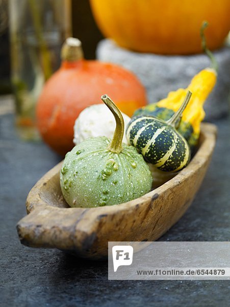 High angle view of various pumpkin in wooden container