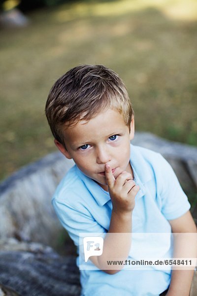 Portrait of boy with finger on lips