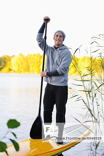 Portrait of man on paddle board in water