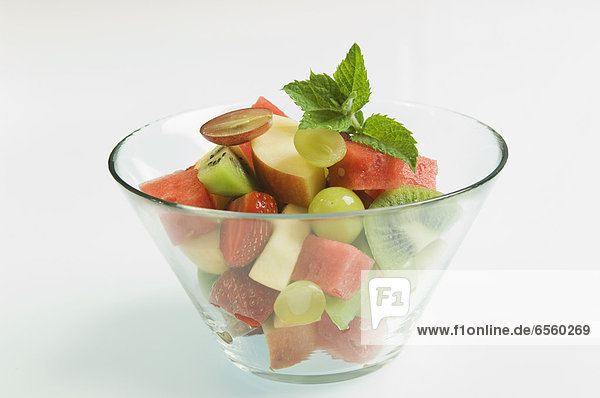 Bowl of fruit salad on white background