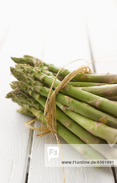 Bundle of green asparagus on table