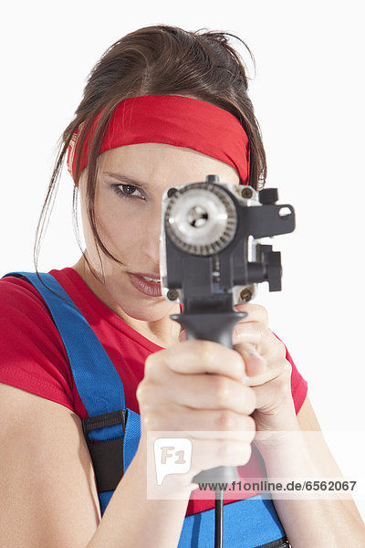 Young woman holding electric drill  portrait