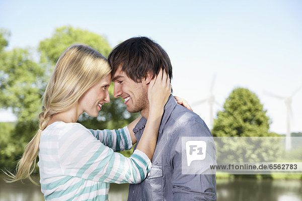 Germany  Cologne  Young couple embracing  smiling