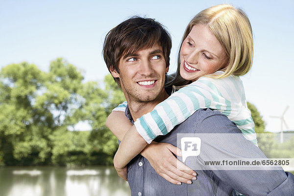 Germany  Cologne  Young couple embracing  smiling