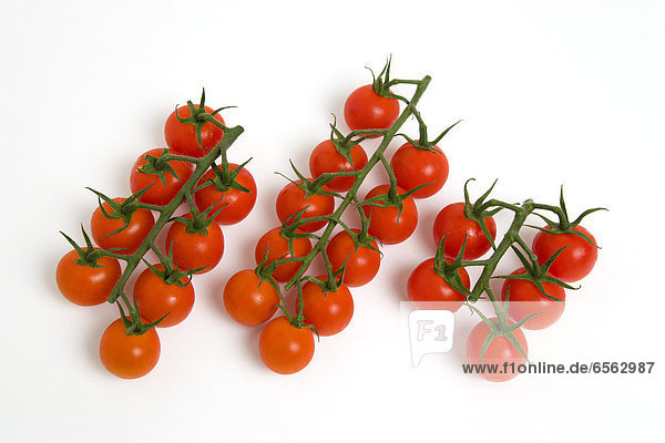Ripe red cherry tomatoes on white background