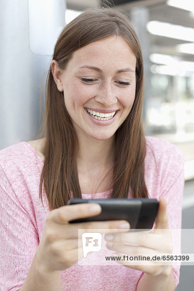 Young woman watching smart phone