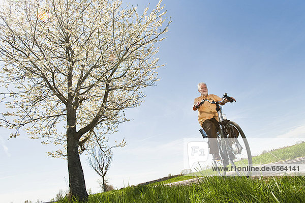 Senior man riding electric bicycle