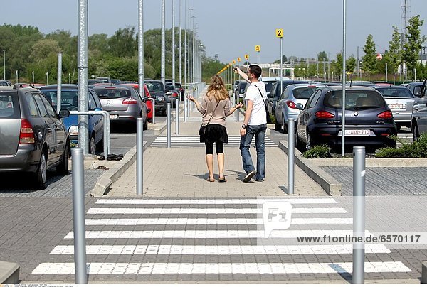 Young couple traveling by train. Young couple in the parking area of a station *** Local Caption ***