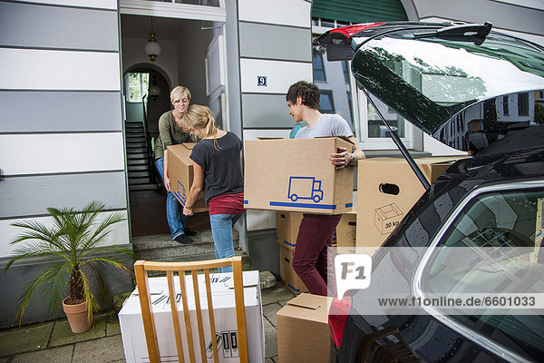 Private relocation  friends helping to unload a car