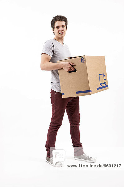 Young man carrying a moving box