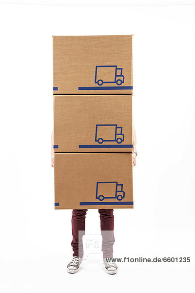 Young man carrying moving boxes