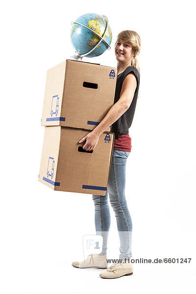 Young woman carrying moving boxes and a globe