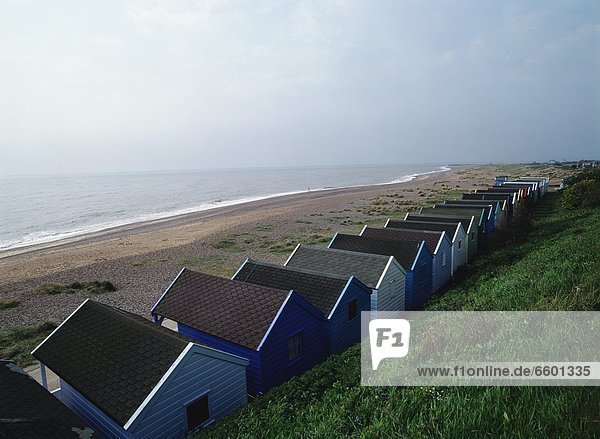 Beach Huts Lined Up Along The Coast In Southwold  England