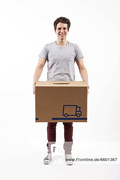 Young man carrying a moving box