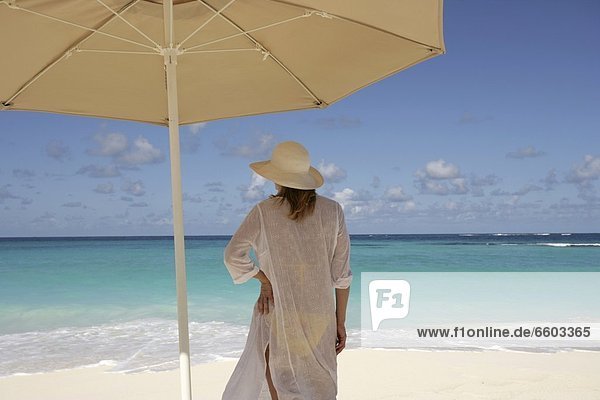 Woman On A Tropical Beach Under An Umbrella