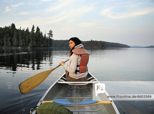 Woman Canoeing On A Lake
