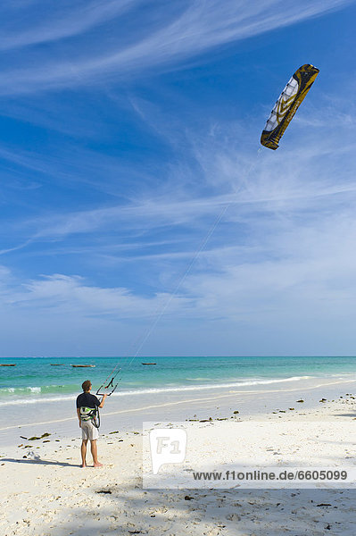Kite surfer practicing on the beach of Paje  Zanzibar  Tanzania  Africa
