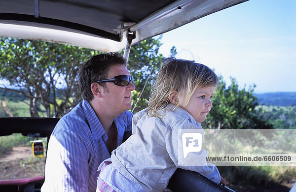 Father And Young Daughter On Safari In Jeep