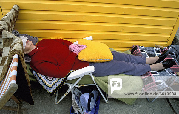 Person Sleeping On Sidewalk