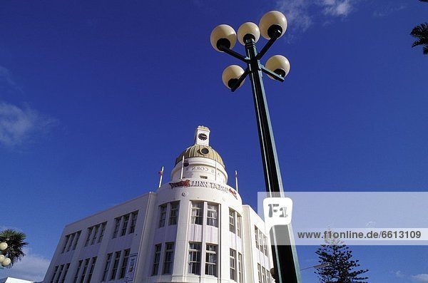 Street lamp in front of art deco building  low angle view