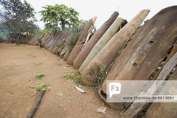 Fence made from cluster bomb casings from American bombing between 1964 and 1973  Hmong village near Phonsavan in Northern Laos
