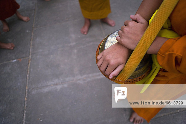 Novice monks out collecting alms at dawn in Luang Prabang low section  Laos