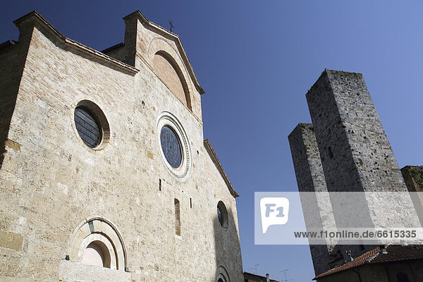 Church And Two Of The Towers Of San Gimignano  A Famous Medieval Hilltop Town With Old Towers  In Tuscany. Italy. June. © Paul Quayle / Axiom