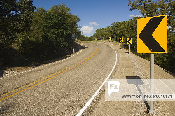 Yellow Curve Ahead Warning Signs On Ranch Road 187 Heading North In Bandera County  Texas  Usa © James Sparshatt / Axiom