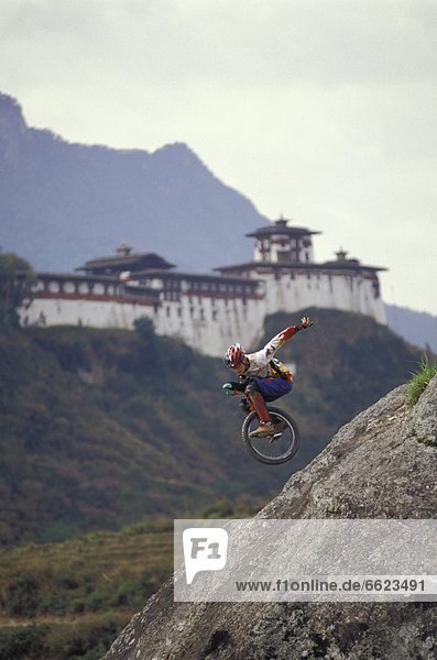 Unicyclist Riding Down Hill