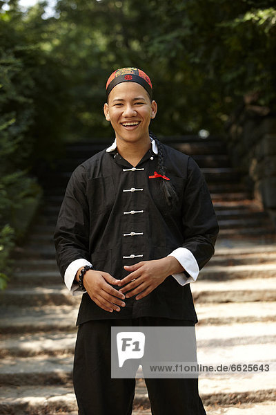 Smiling man in traditional Asian clothing