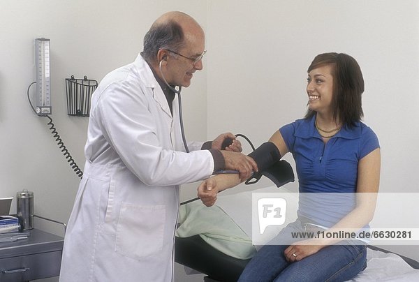 A Doctor Checking A Patient's Blood Pressure