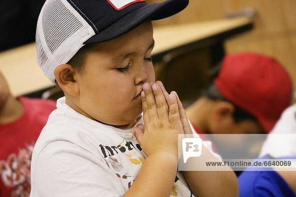 Child In Baseball Cap Praying