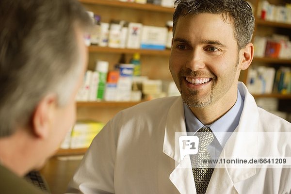 Pharmacist Smiling At Patient