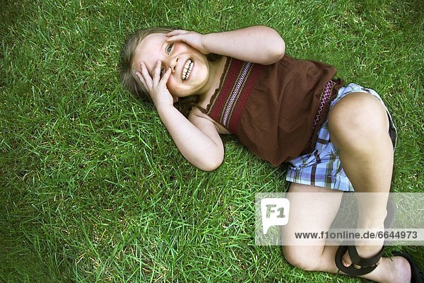 Little Girl Laying On Grass
