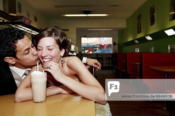 Front View Of A Couple Drinking In A Restaurant