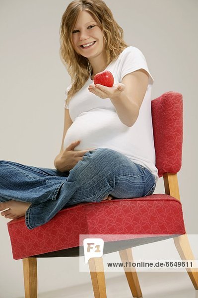 A Pregnant Woman Holding Apple