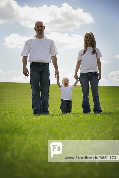 A Family Walking On Grass
