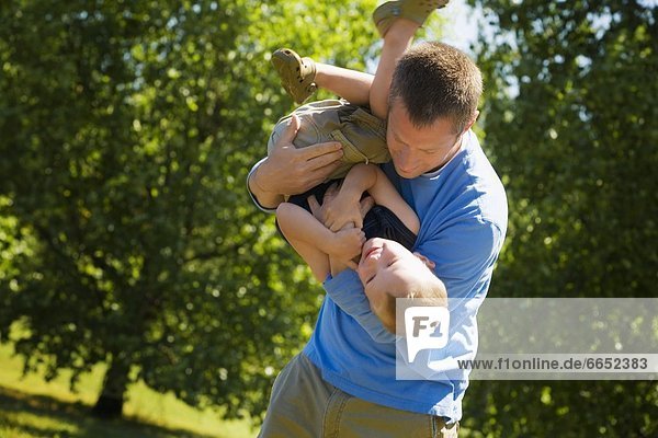 Front View Of Father Playing With Son
