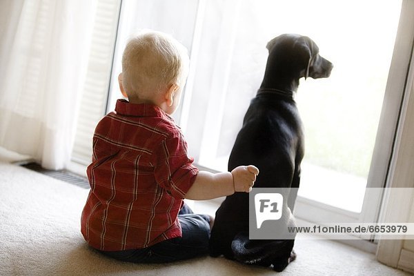 Boy Sitting With Dog