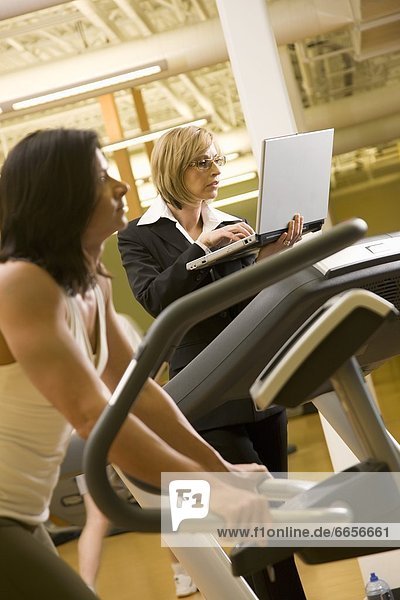 Businesswoman Using A Computer While On The Treadmill