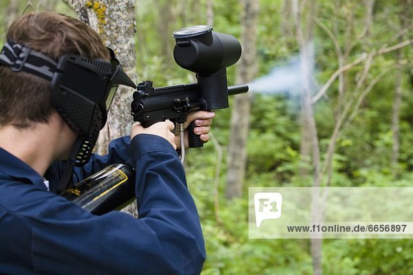 Man Shooting Paintball Gun