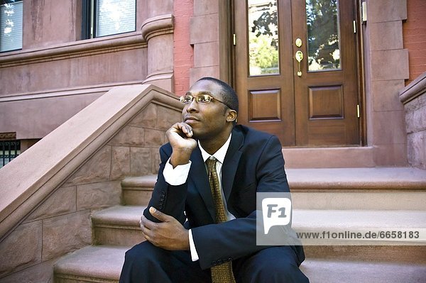 Man Sitting In Front Of Brownstone  Harlem  New York City  New York  Usa