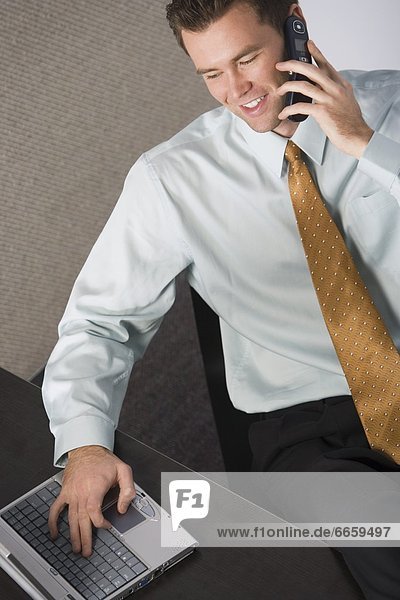 Businessman On The Phone And His Laptop
