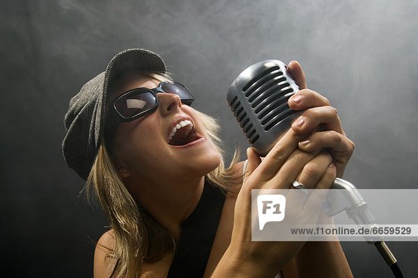 Woman Singing In A Microphone
